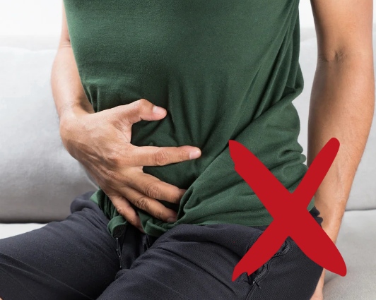 Person mit Bauchschmerzen und Blähungen; Symbol für Verdauungsprobleme durch Hülsenfrüchte.